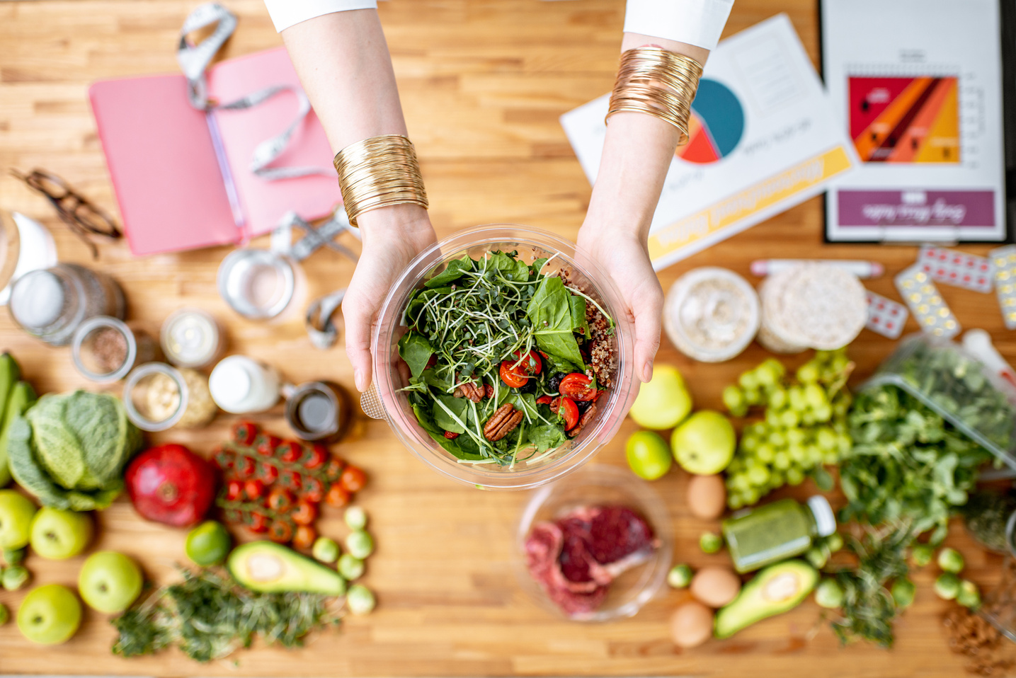 Dietitian Holding Salad above the Table 