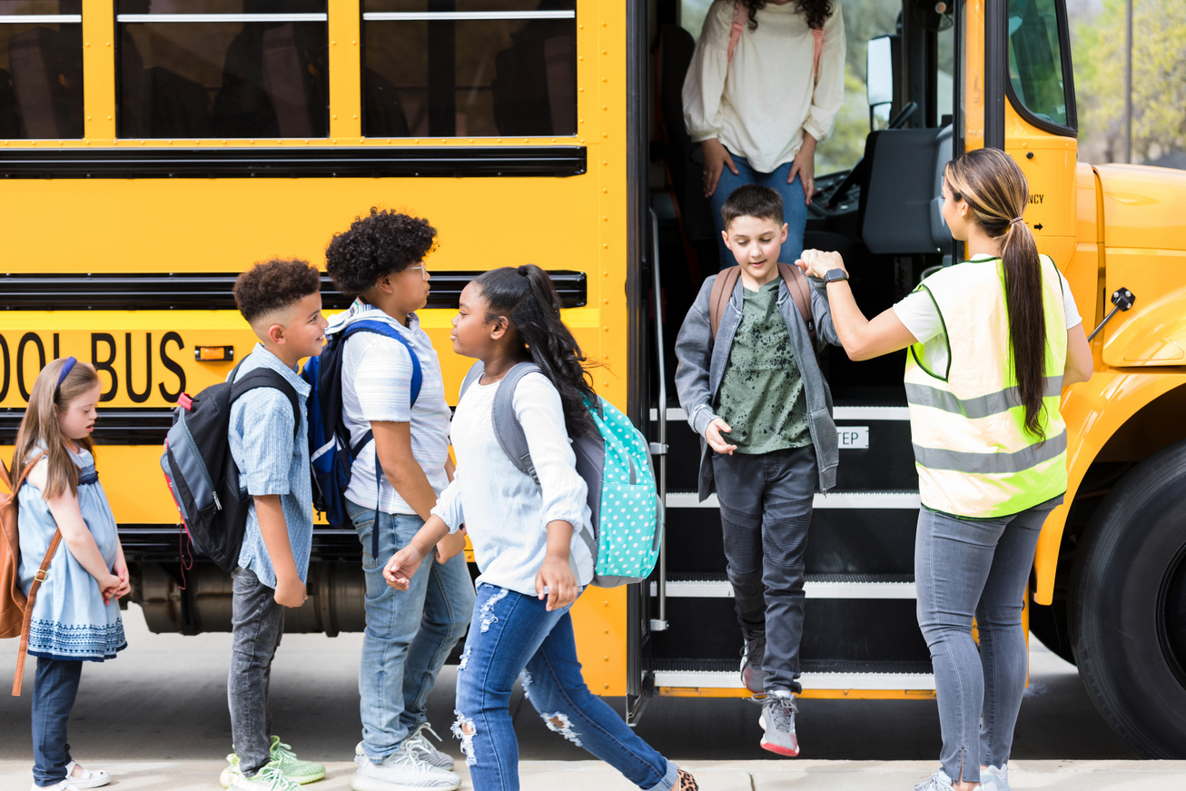 Bus driver helps children step off school bus